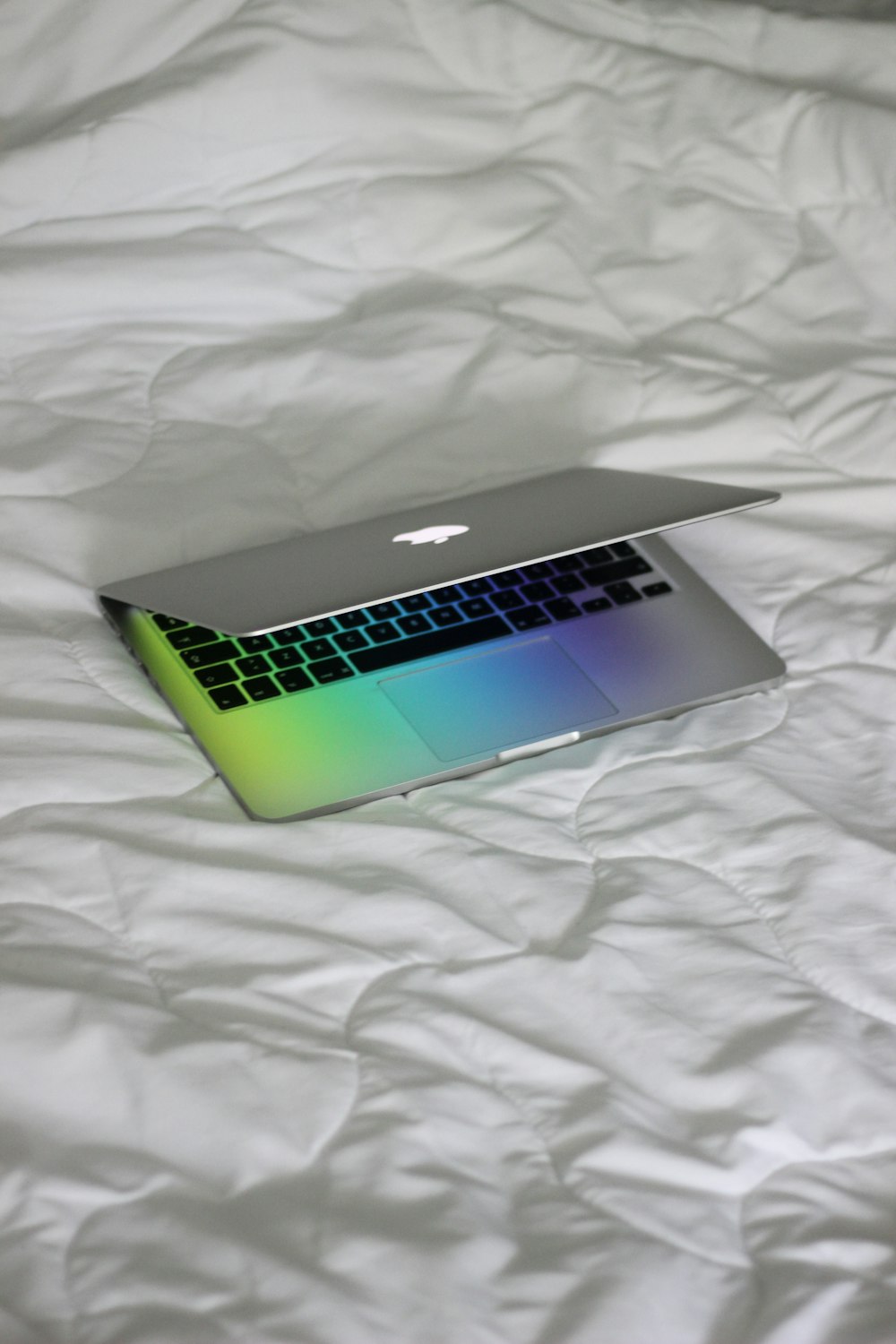 macbook pro on white textile