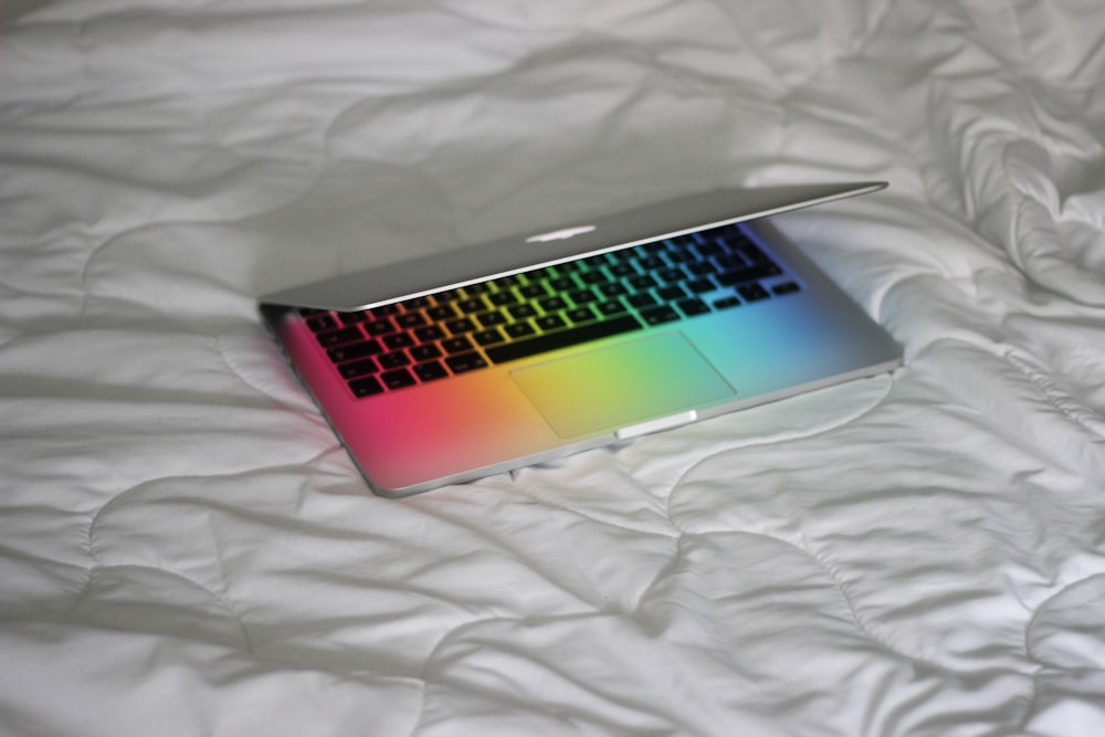 macbook pro on white textile