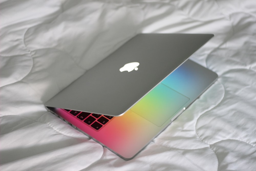 macbook pro on white textile