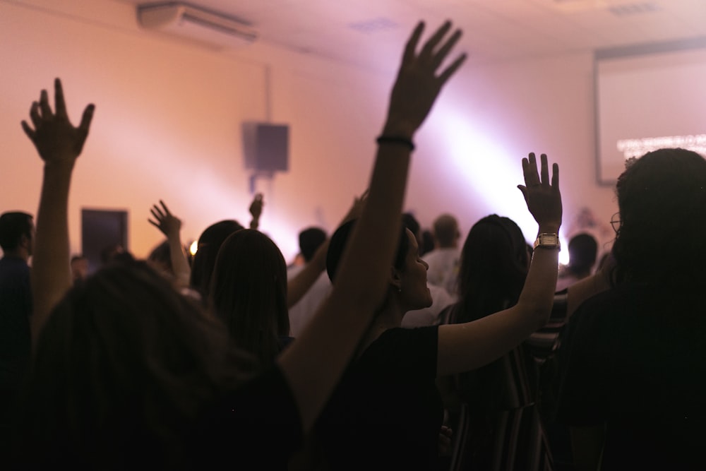 people raising their hands in front of people raising their hands