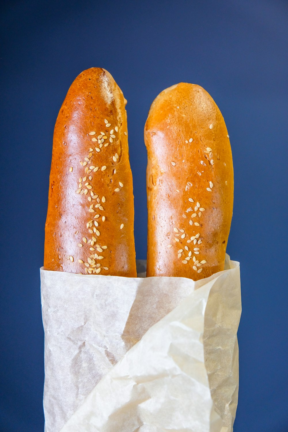 two brown bread on white paper