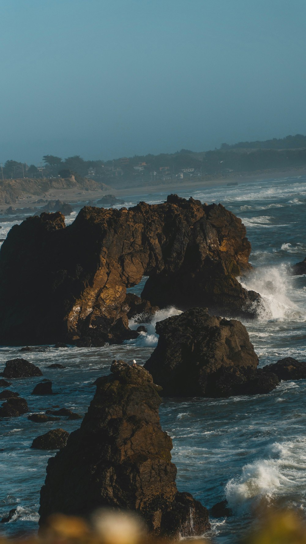 brown rock formation on sea during daytime