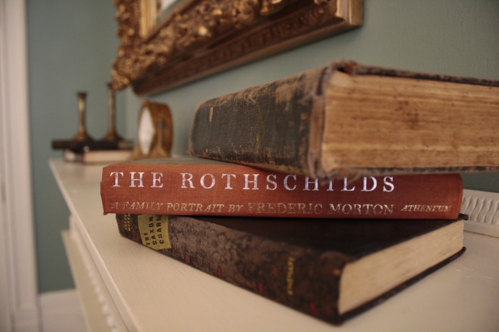 brown hardbound book on white table