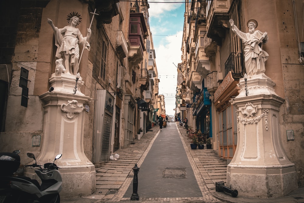 people walking on sidewalk between buildings during daytime