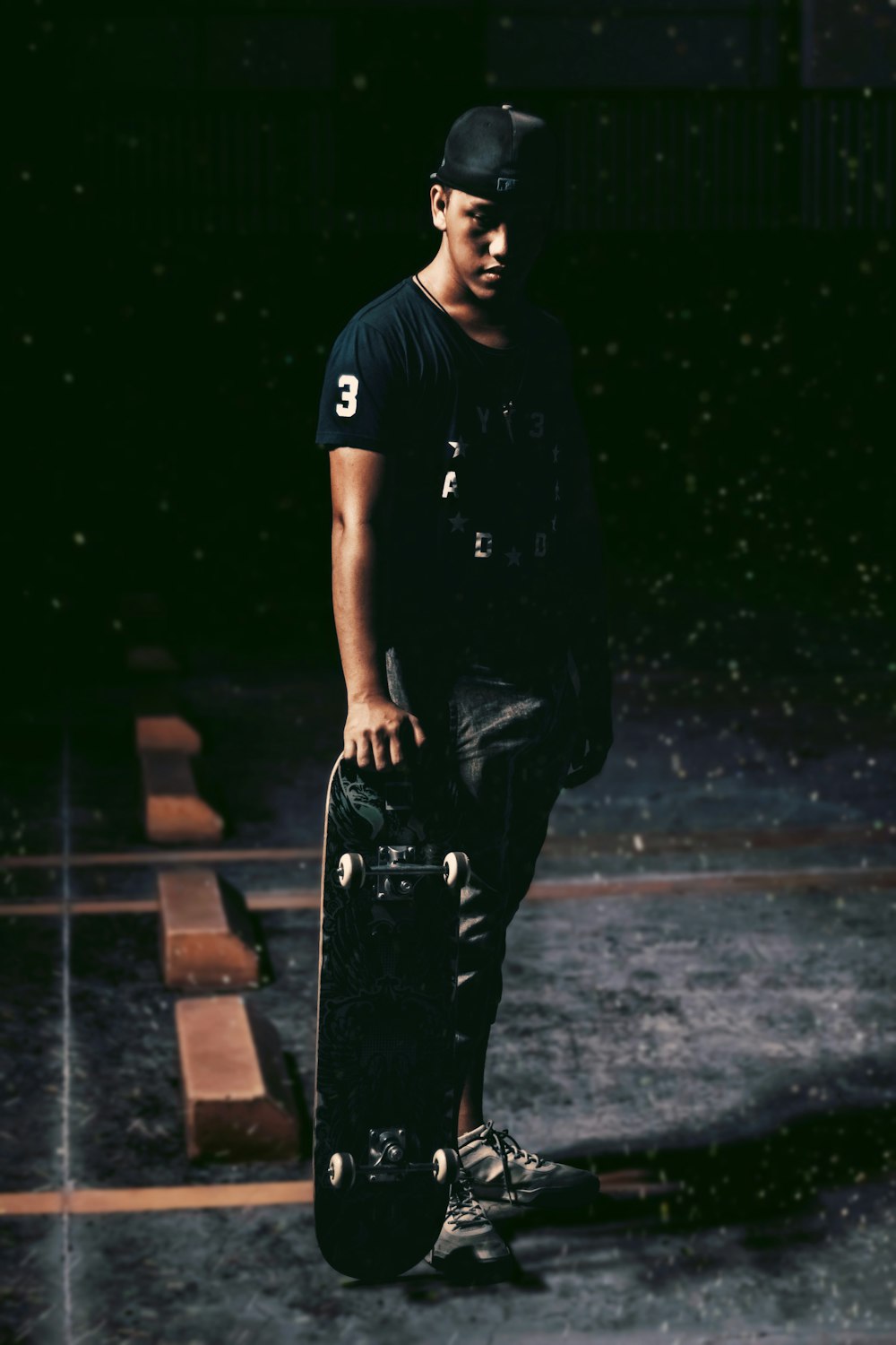 man in black crew neck t-shirt and black pants standing on brown concrete floor