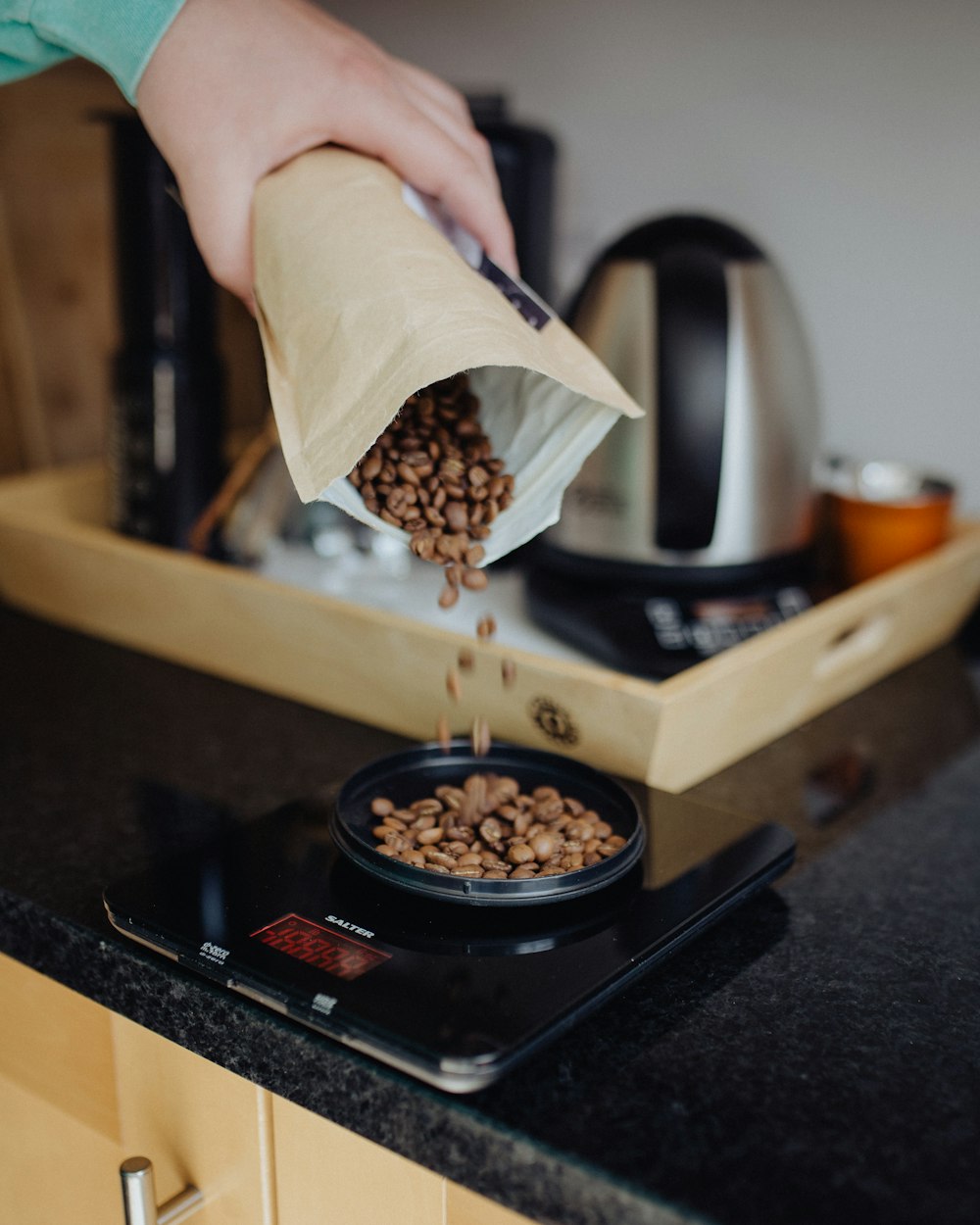 person holding brown paper bag with brown and black food