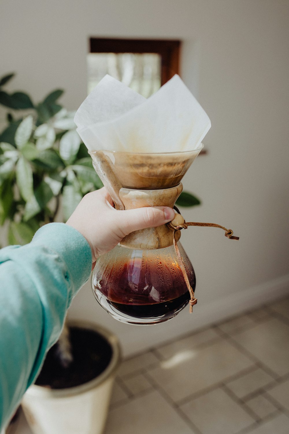 person holding brown glass jar