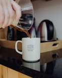 person holding clear glass cup