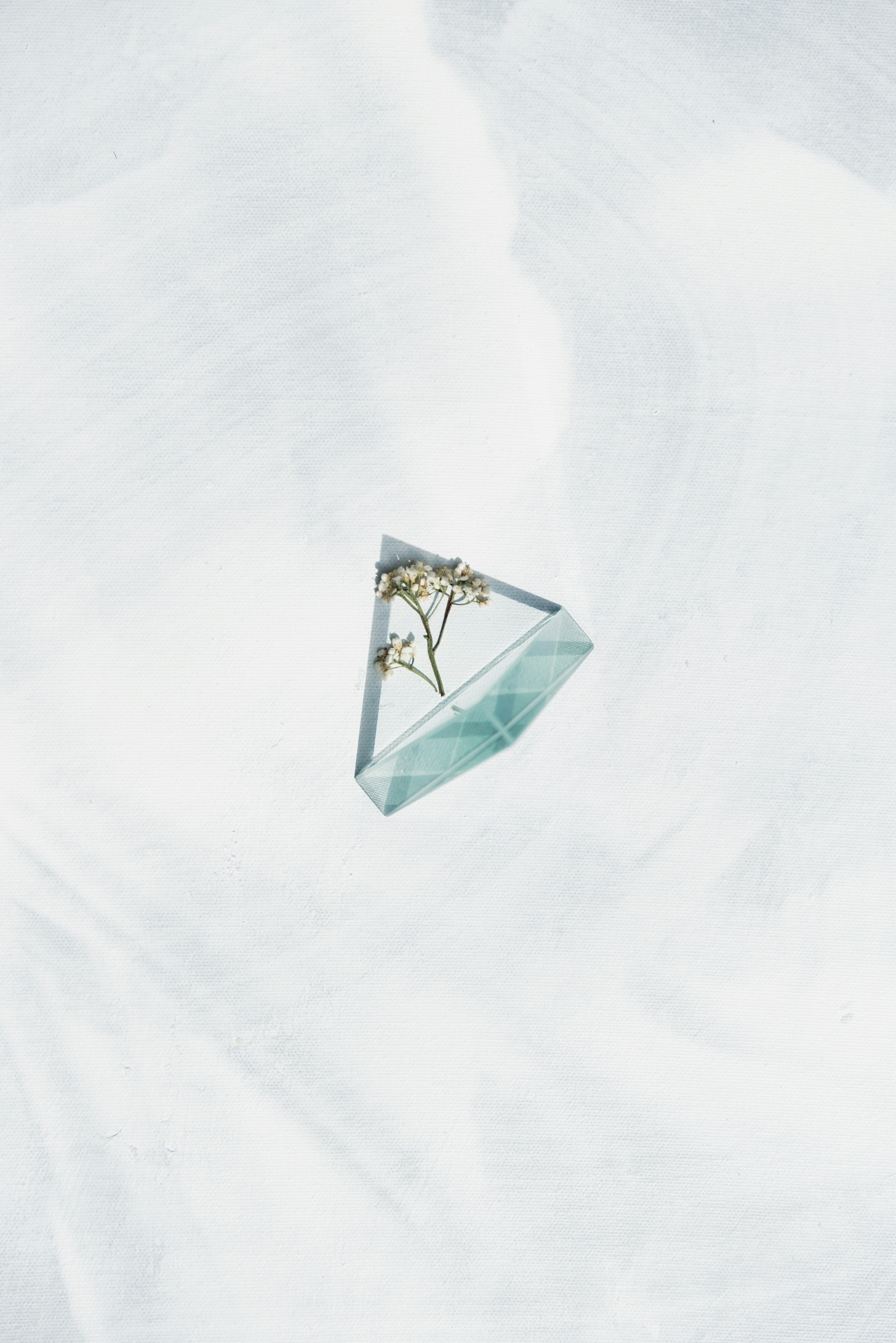 white and blue floral paper on white textile