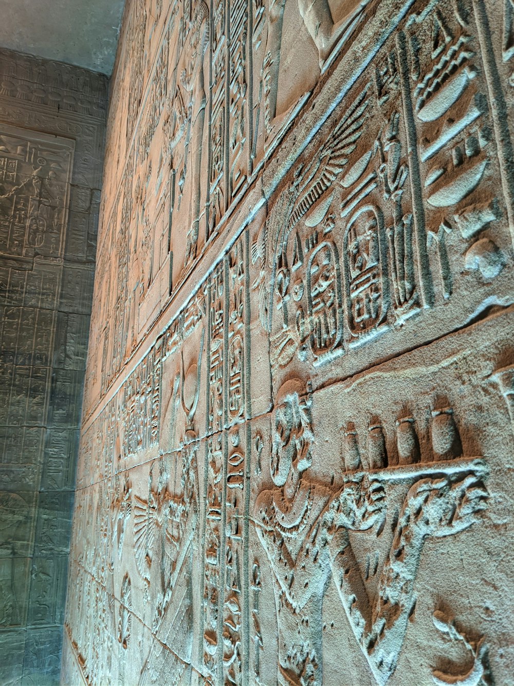 brown concrete wall with carved human face