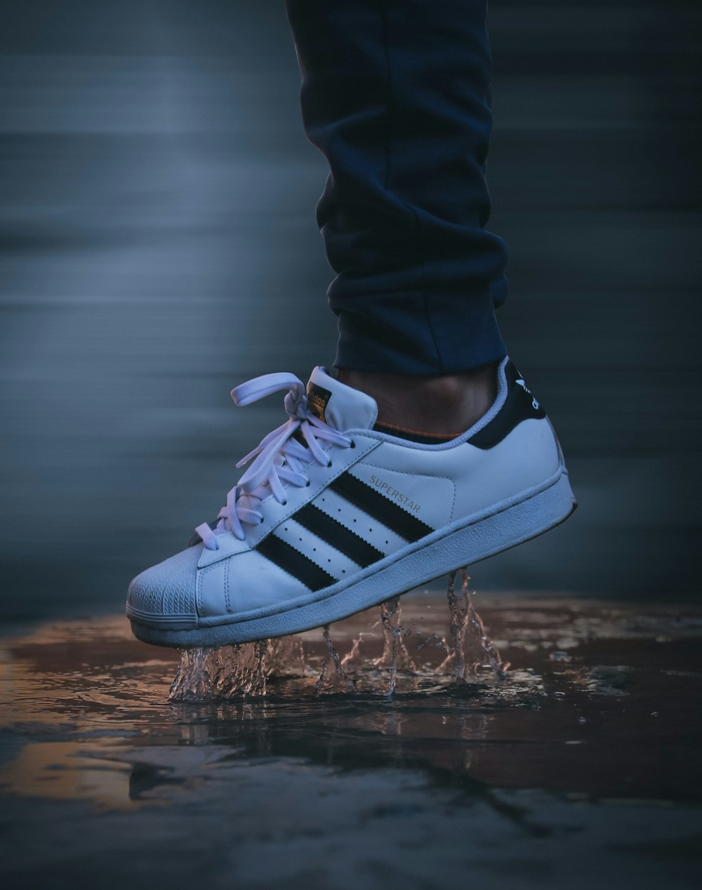 person wearing white and black adidas sneakers photo – Free Image on  Unsplash