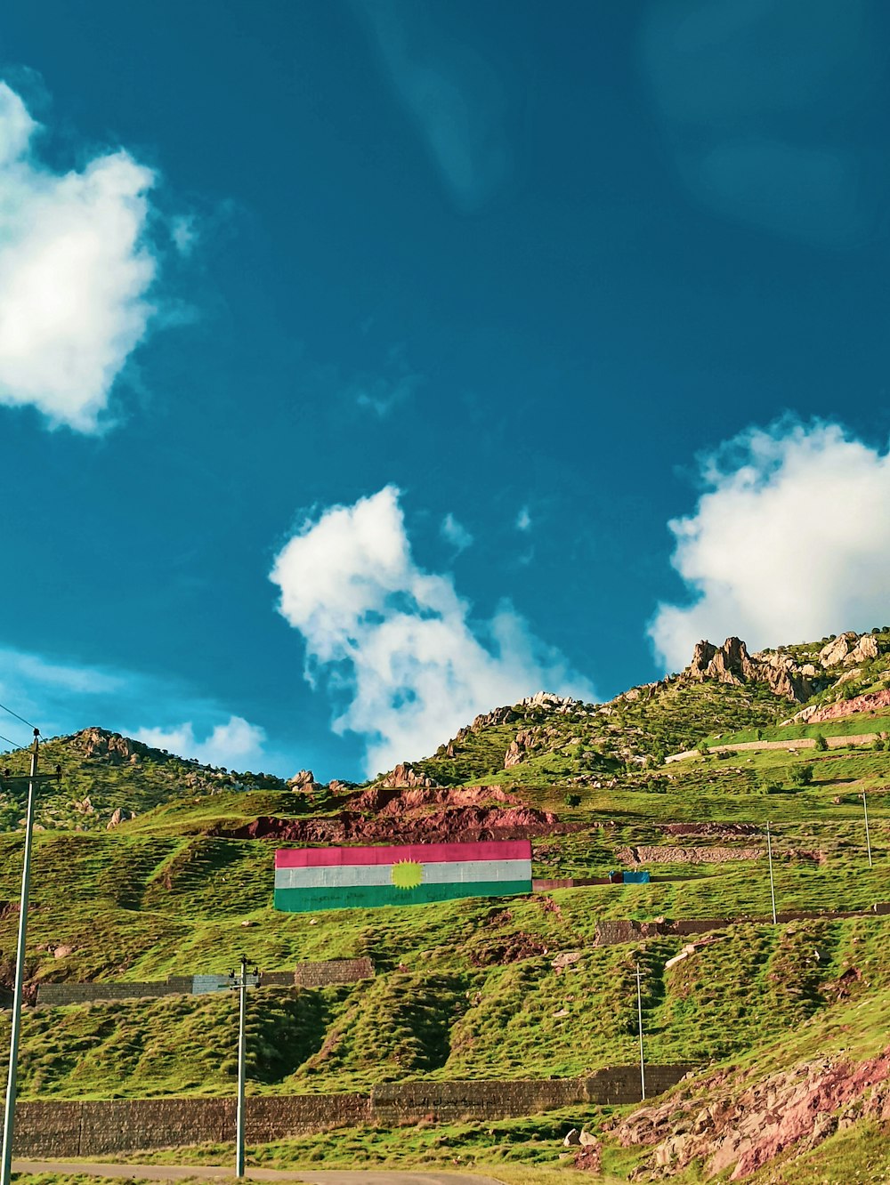 green and brown mountain under blue sky and white clouds during daytime