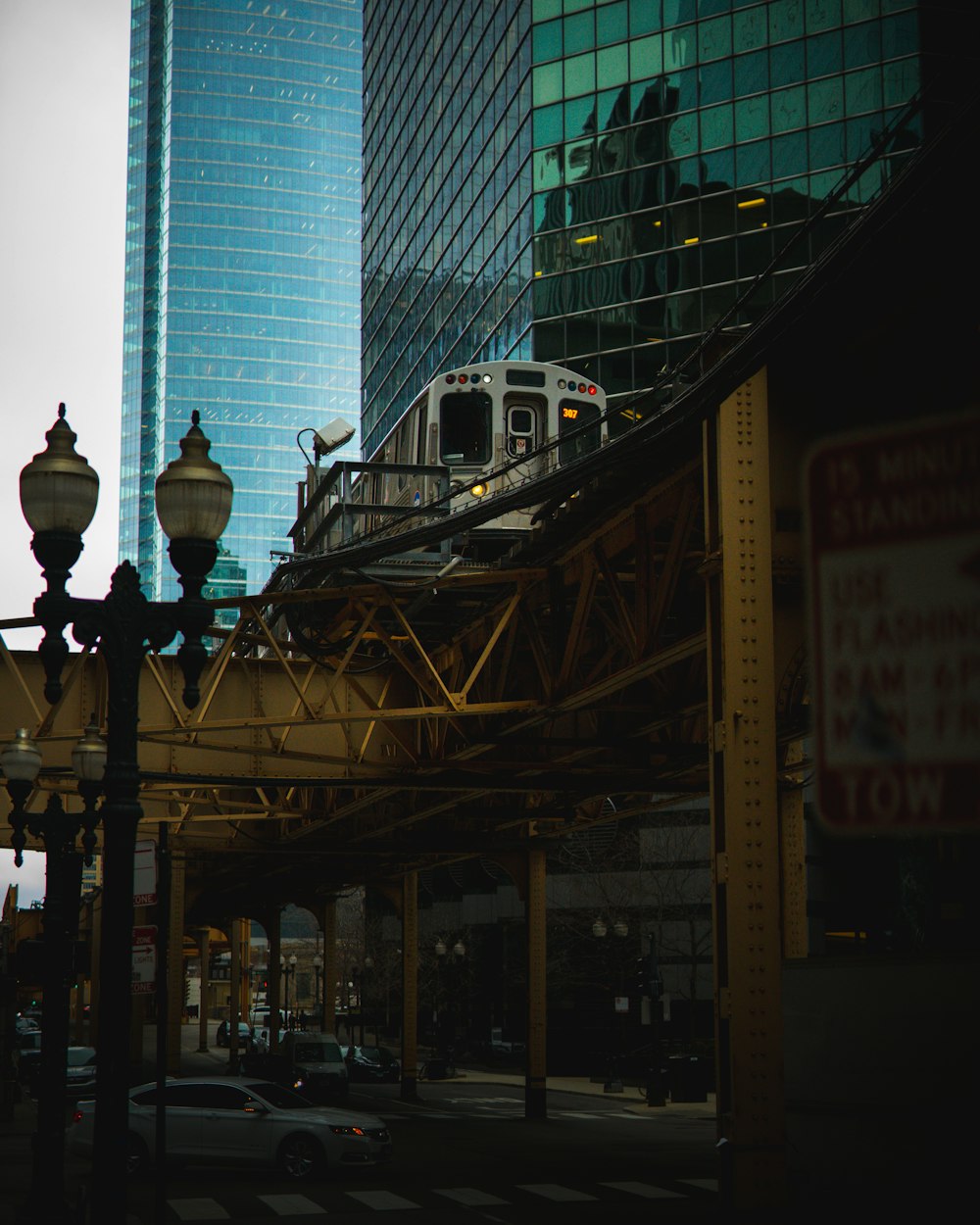 white and black street lamp near white and blue building during daytime