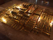 Stacks of gold bars ready for shipment at a secure warehouse in Uganda.
