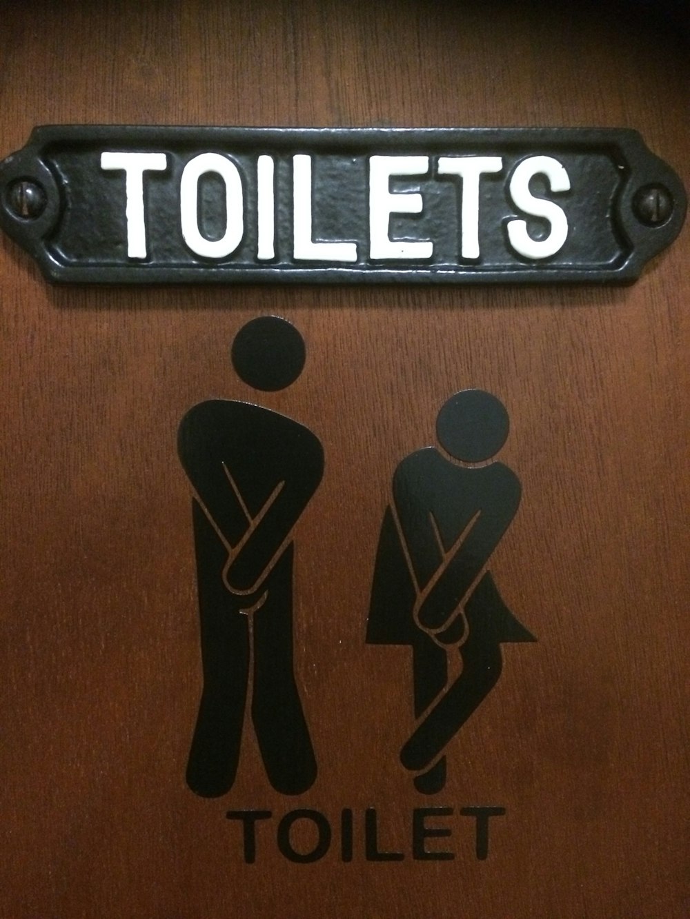 a toilet sign with a picture of a man and a woman