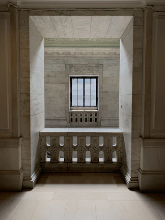 Elegant treatment area with marble surfaces and subtle stone accents under soft daylight.