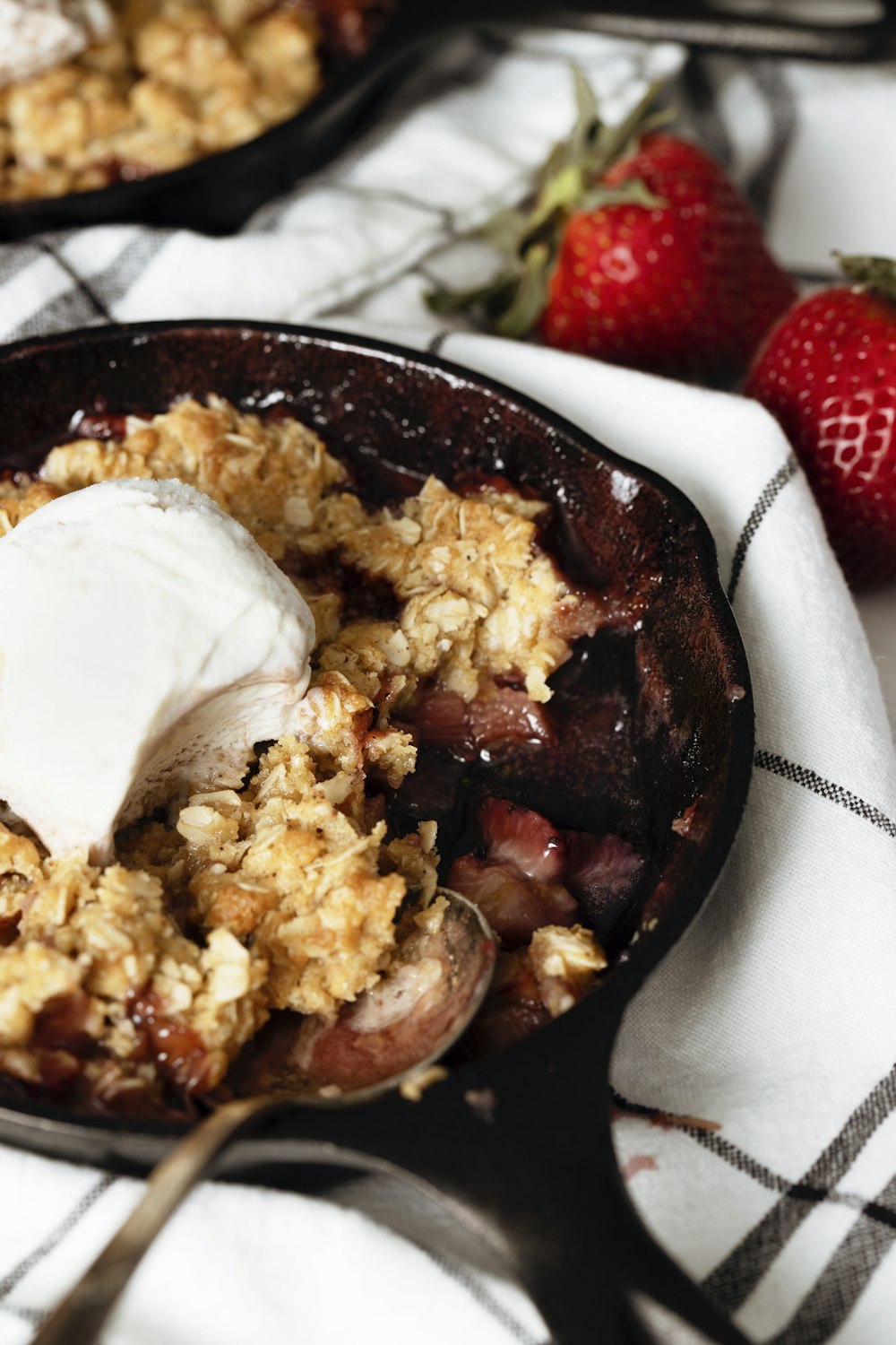 white ice cream on black ceramic bowl