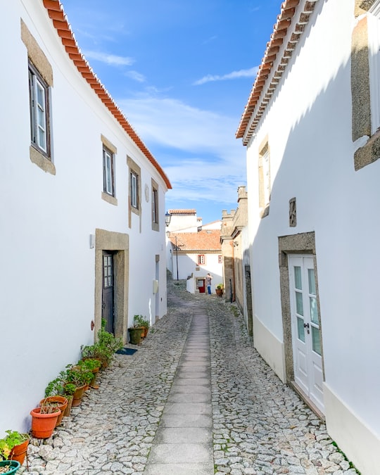 white and brown concrete houses under blue sky during daytime in Marvão Portugal
