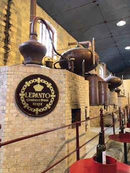 A sophisticated mezcal distillery tour with elegant lighting and traditional copper stills.