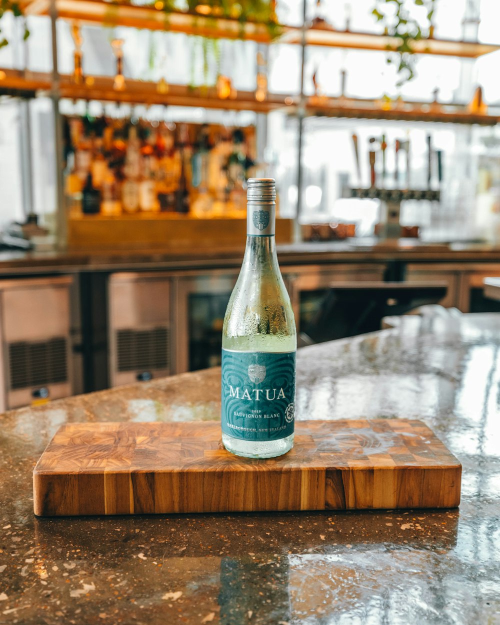 clear glass bottle on brown wooden table