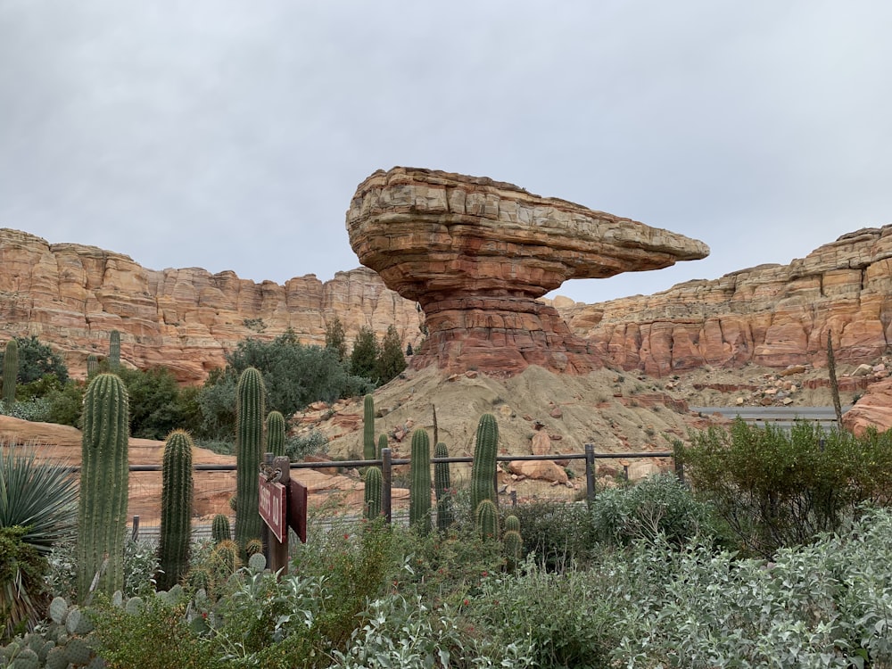 brown rock formation under white clouds during daytime