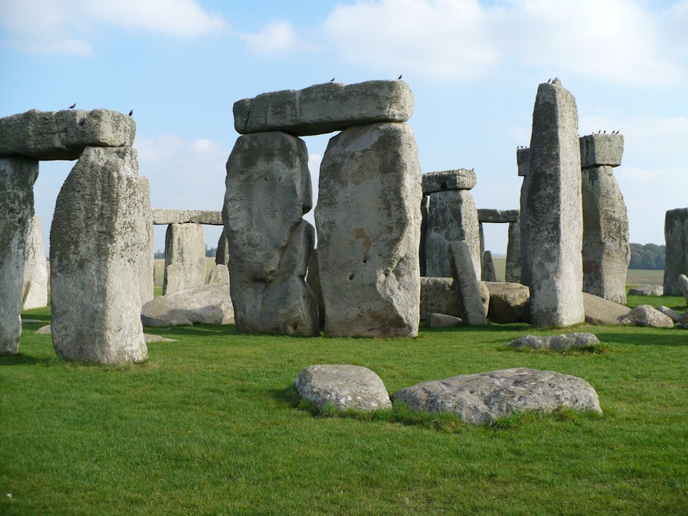 gray rock formation on green grass field during daytime