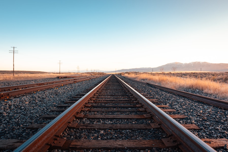 Parallel railway tracks under a blue sky, representing two embedding index versions running side by side through a cutover