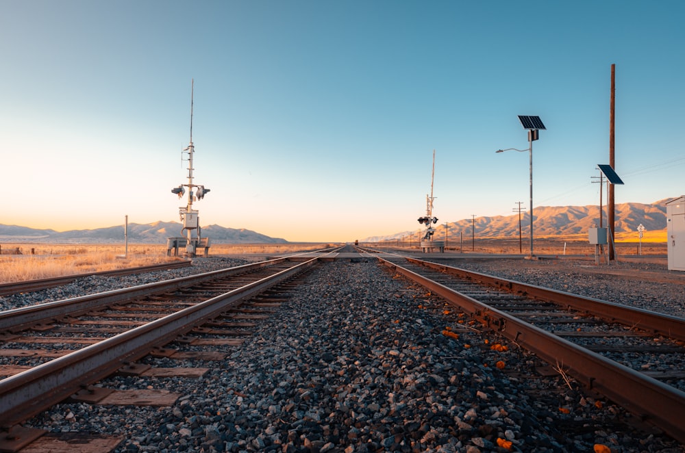 train rail tracks under blue sky during daytime