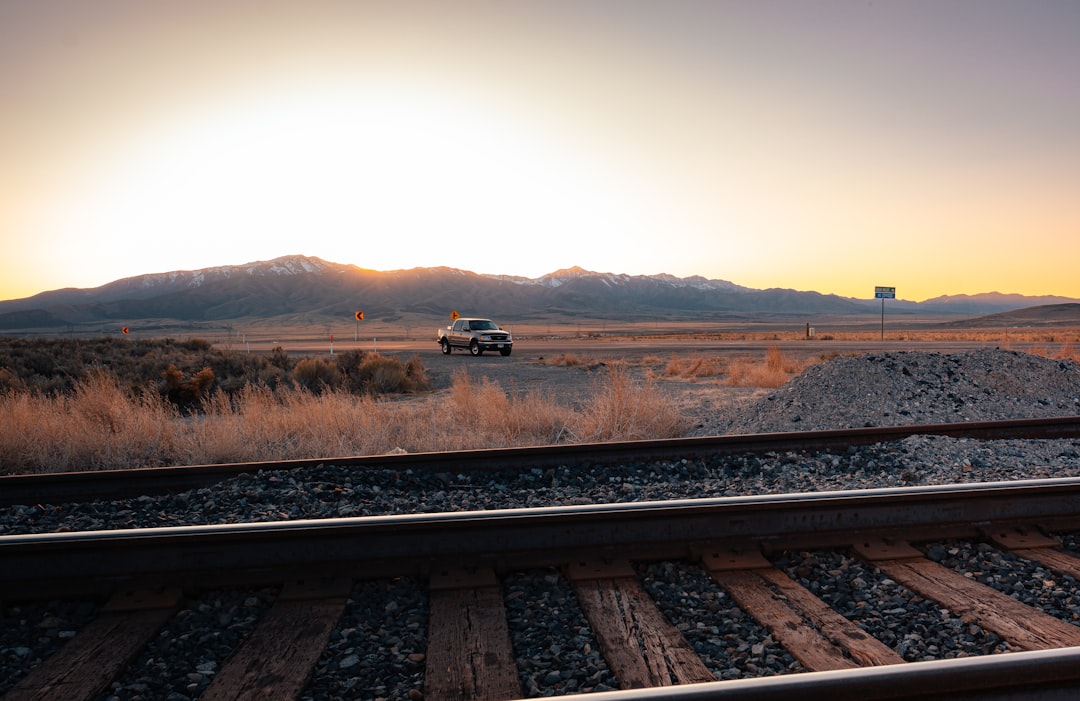 black car on rail road during daytime