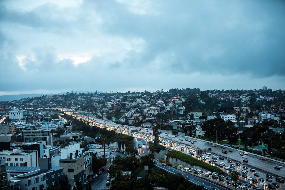 city with high rise buildings under white clouds during daytime