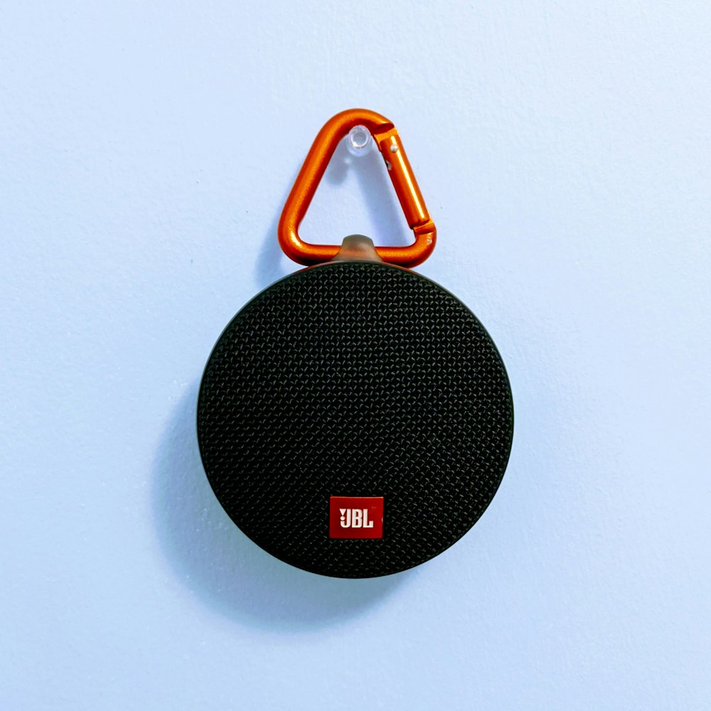black and orange jbl portable speaker