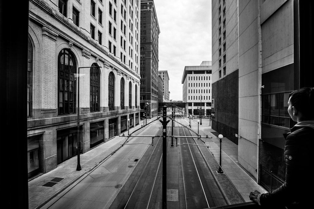 grayscale photo of a road in the middle of a city