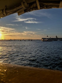 A panoramic view of NASC’s fleet anchored near Guyana’s coastline under a golden sunset.