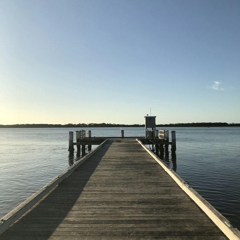 brown wooden dock on sea during daytime