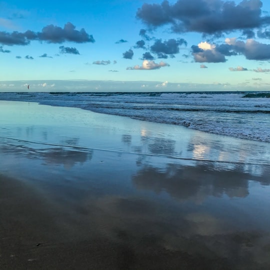 sea waves crashing on shore under blue and white cloudy sky during daytime in Sunshine Coast Australia