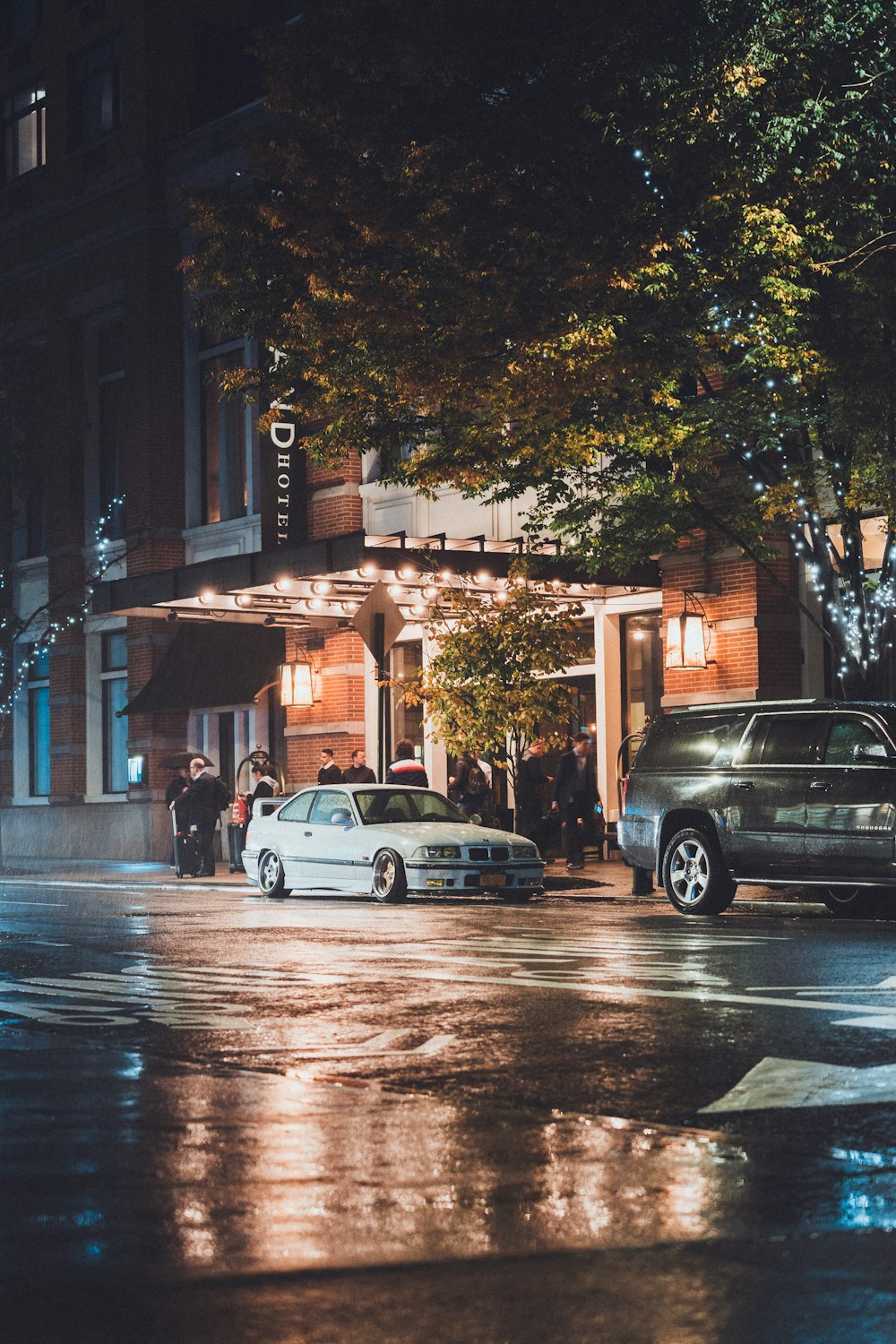 a couple of cars parked on a wet street