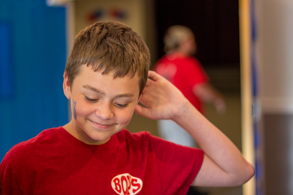 boy in red crew neck t-shirt