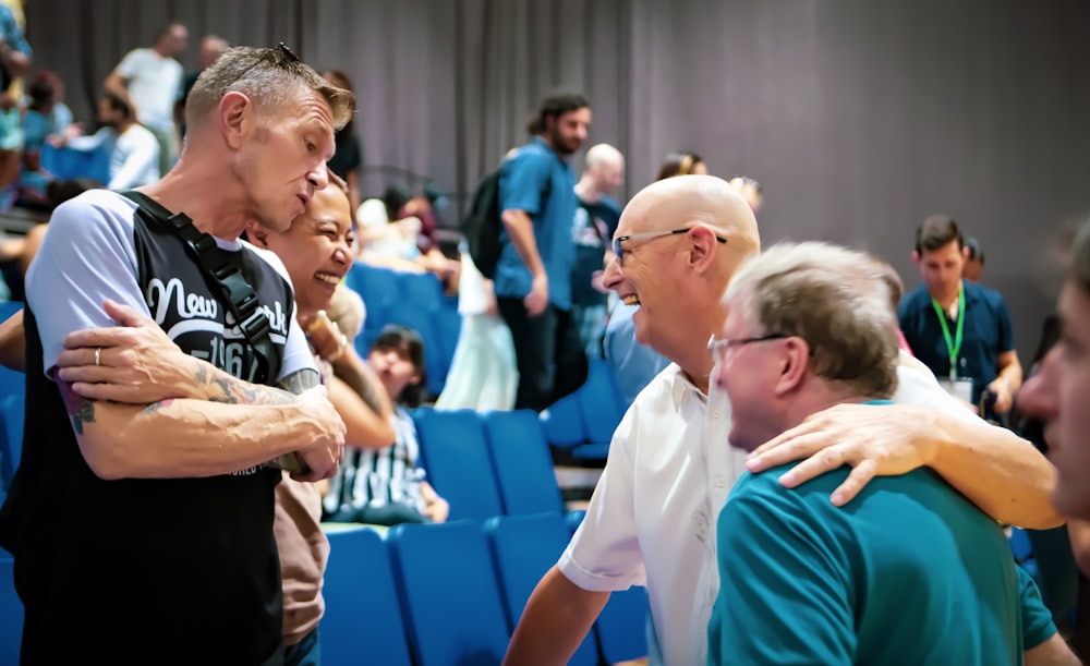 woman in white shirt standing beside man in green shirt