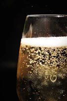 clear glass with beer on black background