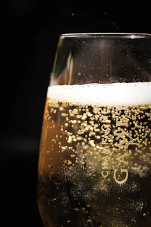 clear glass with beer on black background