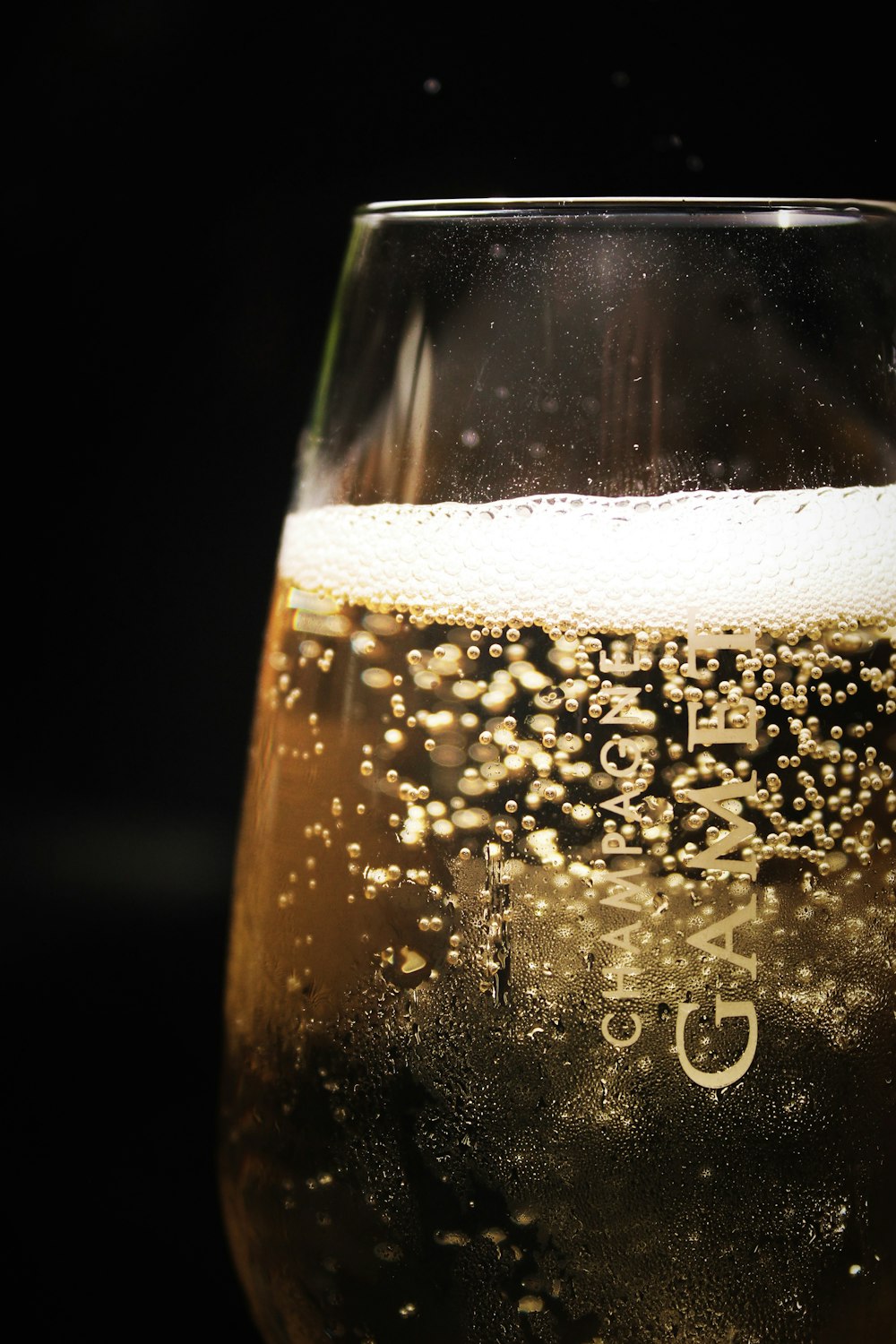 clear glass with beer on black background