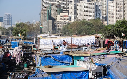 people standing on blue boat during daytime in Mumbai India