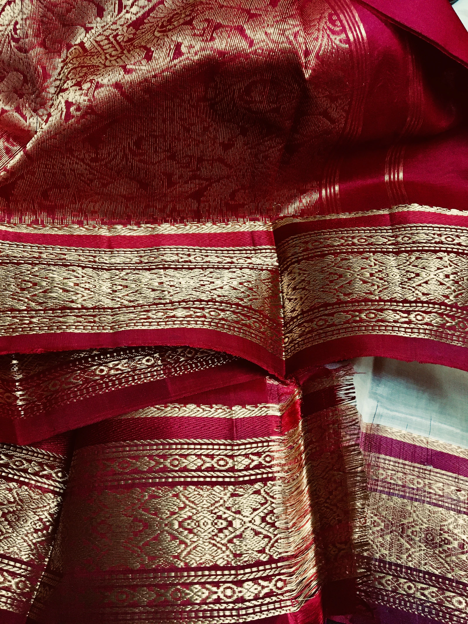 A close-up of red, white, and blue handwoven textile detail