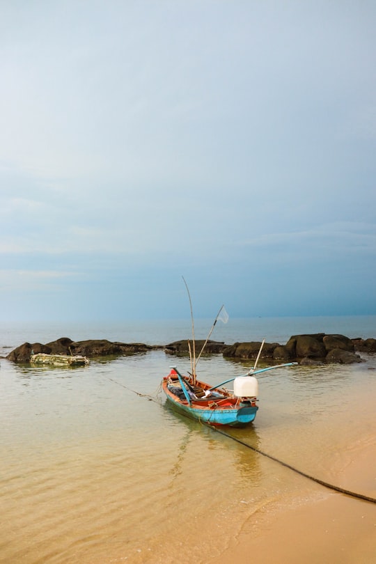 white and blue boat on sea shore during daytime in Phu Quoc Vietnam