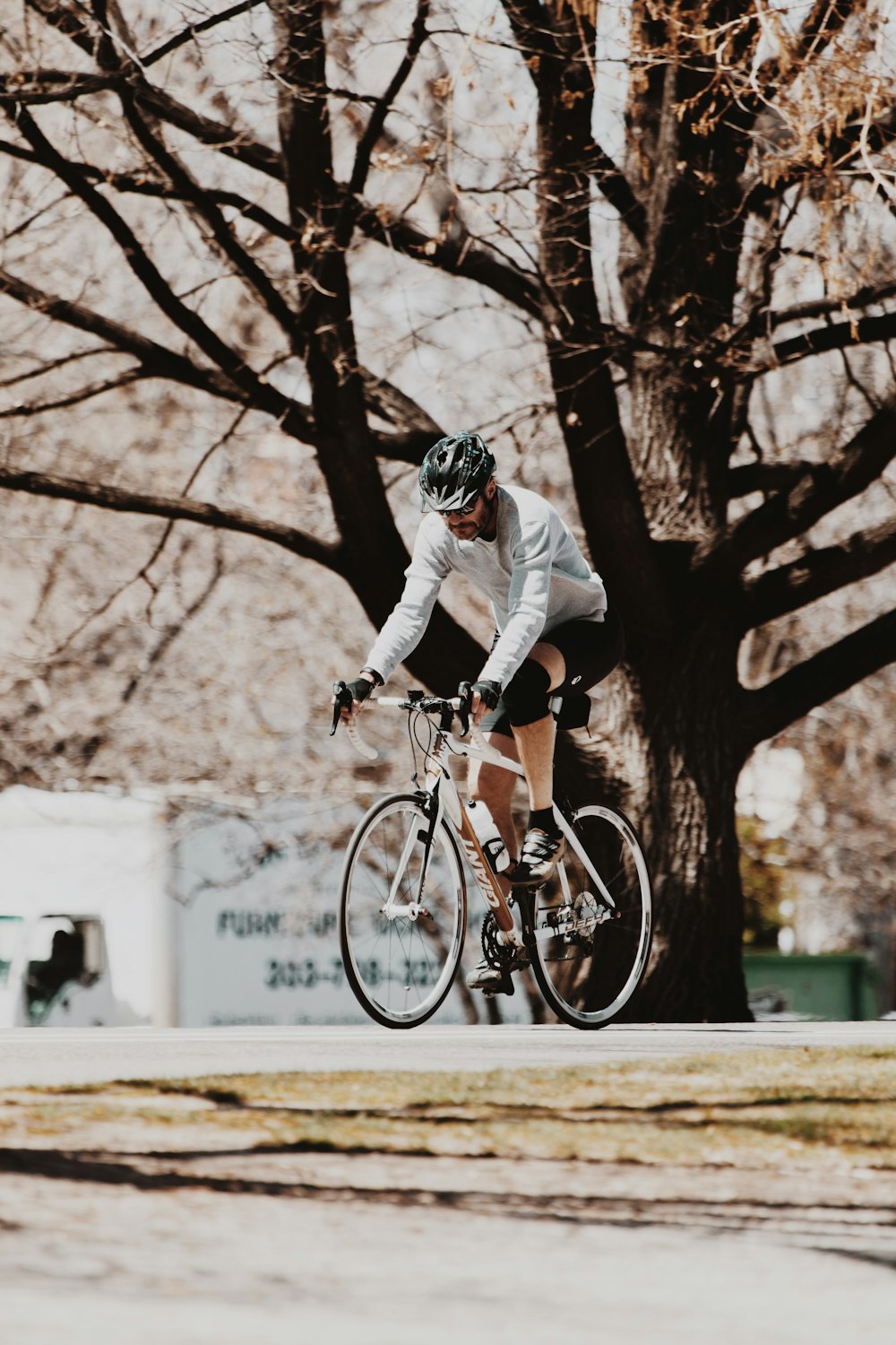 man in white and black jacket riding on red bicycle