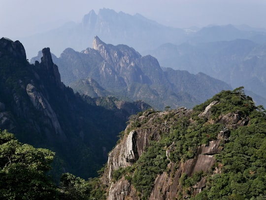 green and brown mountains during daytime in Sanqing Mountain China