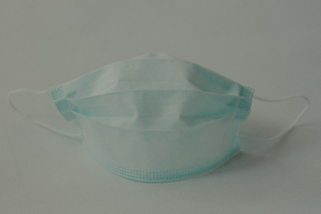 green plastic bowl on white textile