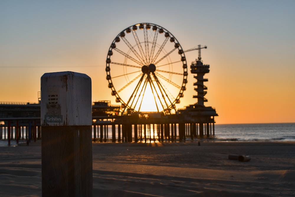 ferris wheel near body of water during daytime