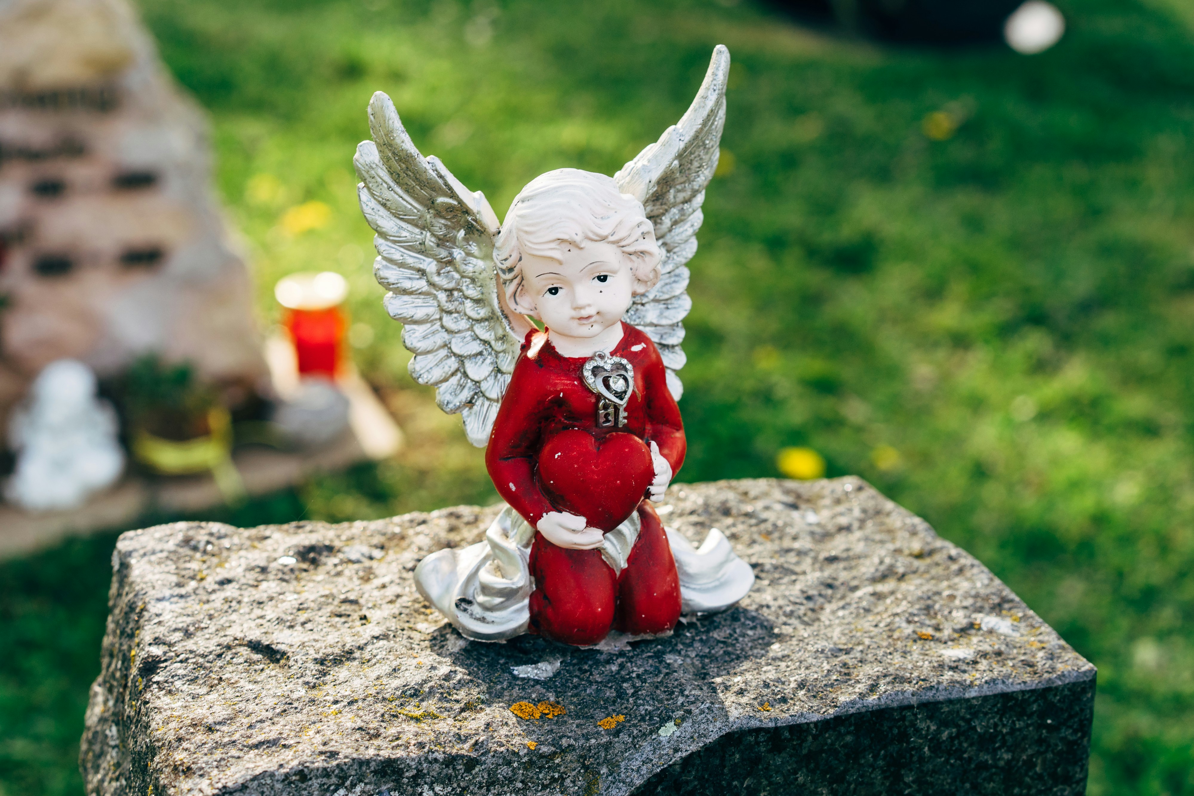 white angel figurine on gray concrete surface