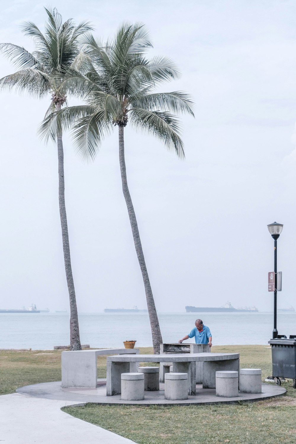 2 people sitting on boat on sea shore during daytime